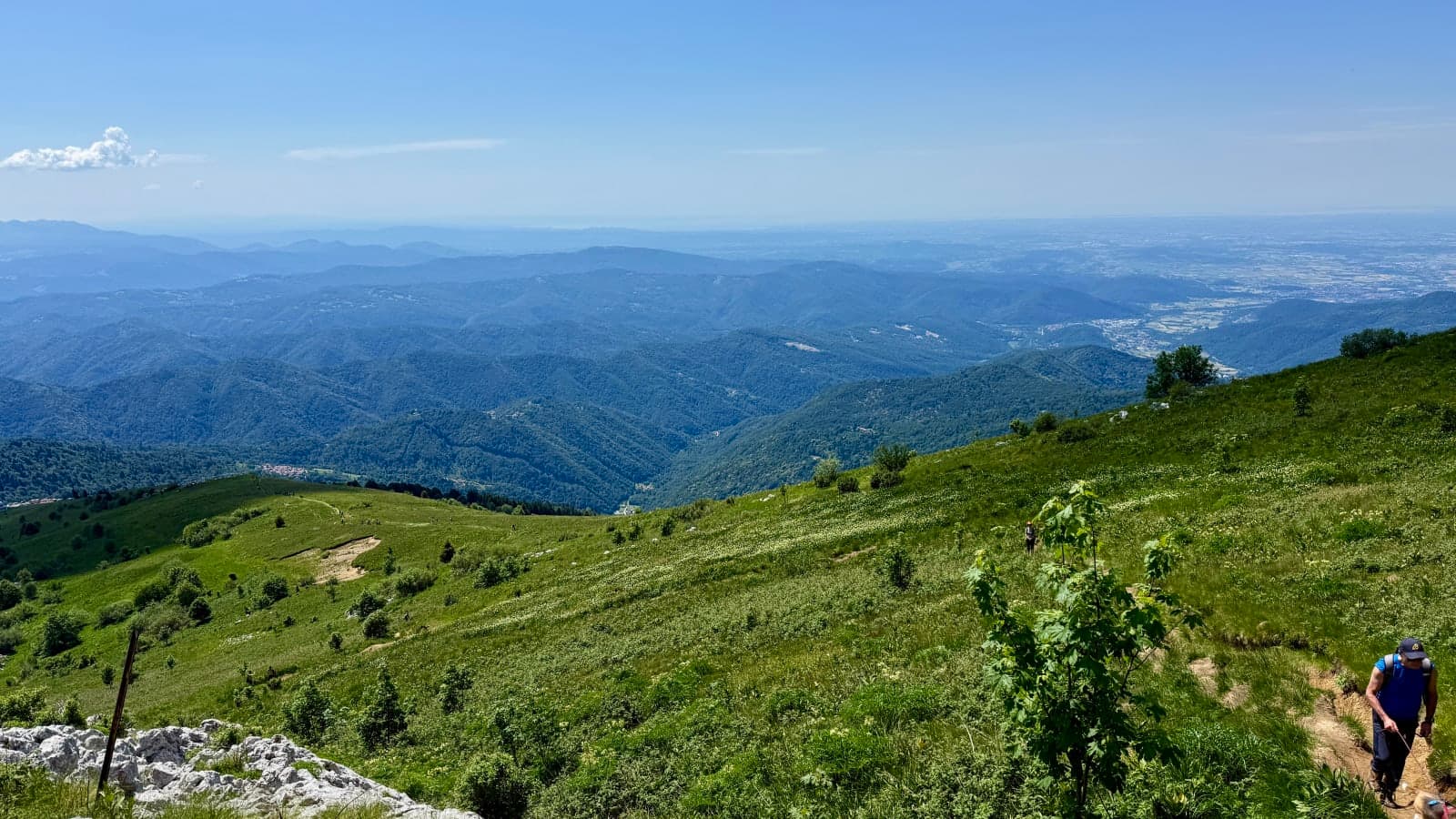 Green slopes and distant valleys below Mount Matajur during race weekend.