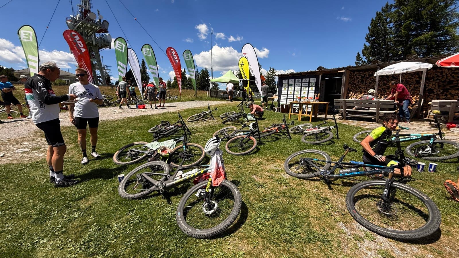 Mountain bikes and riders resting after Schockl Gipfelsturm 2026 near the summit finish.