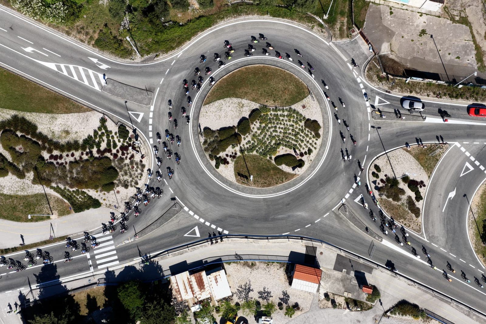 Aerial photo of the Krk Granfondo peloton flowing through a roundabout.